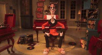 A Cartoon Character Is Sitting In Front Of A Piano And Has A Pair Of Monkey Slippers On GIF