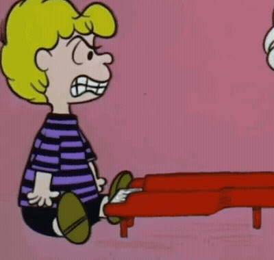 A Cartoon Character Is Sitting In Front Of A Red Piano And Making A Funny Face . GIF