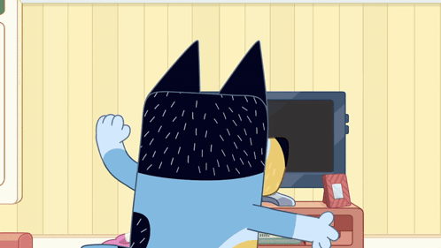 A Cartoon Character Is Sitting In Front Of A Television In A Living Room GIF