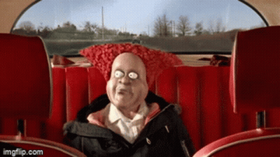 A Cartoon Character Is Sitting In The Back Seat Of A Car With A Red Pillow On His Head GIF