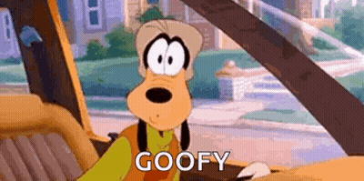 A Cartoon Character Is Sitting In The Driver 'S Seat Of A Car And Says `` Goofy '' . GIF