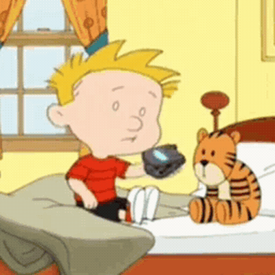 A Cartoon Character Is Sitting On A Bed Holding A Remote Control GIF