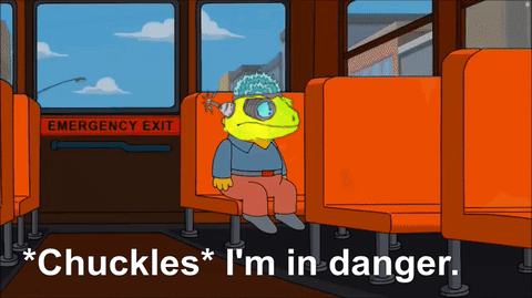 A Cartoon Character Is Sitting On A Bus With The Words " Chuckles I 'M In Danger " Below Him GIF