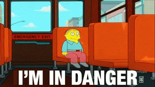 A Cartoon Character Is Sitting On A Bus With The Words I 'M In Danger GIF