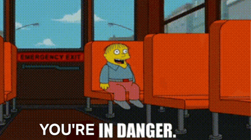 A Cartoon Character Is Sitting On A Bus With The Words " You 'Re In Danger " Below Him GIF