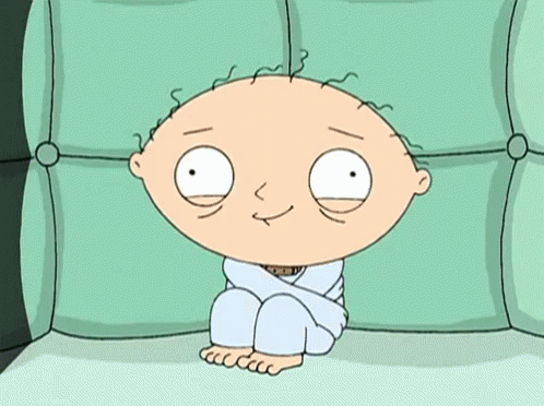 A Cartoon Character Is Sitting On A Green Couch GIF