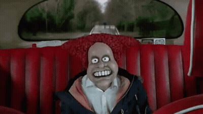 A Cartoon Character Is Sitting On A Red Couch In A Car With A Big Smile On His Face . GIF