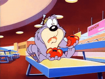 A Cartoon Character Is Sitting On A Table Eating Tomatoes In A Cafeteria . GIF