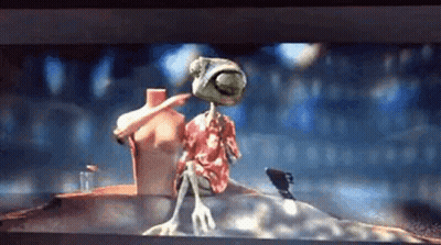 A Cartoon Character Is Sitting On A Table With A Woman GIF