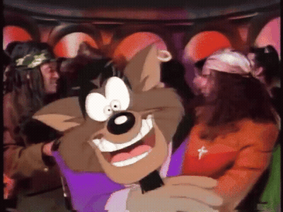 A Cartoon Character Is Smiling And Holding A Microphone In Front Of A Group Of People GIF