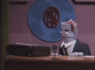 A Cartoon Character Is Standing In Front Of A Sign That Says ' Ti ' GIF