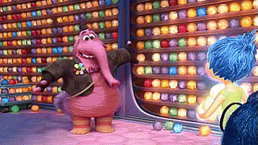 A Cartoon Character Is Standing In Front Of A Wall Of Colored Balls GIF