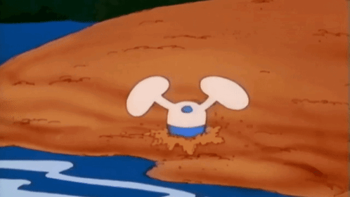 A Cartoon Character Is Standing In The Dirt Near A Body Of Water . GIF