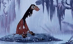 A Cartoon Character Is Standing In The Rain On A Rock . GIF
