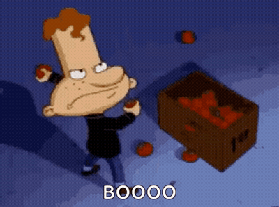 A Cartoon Character Is Standing Next To A Box Of Tomatoes And Saying Booo GIF