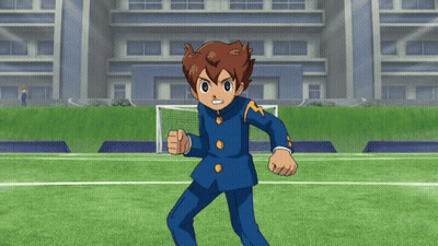 A Cartoon Character Is Standing On A Soccer Field In Front Of A Building GIF