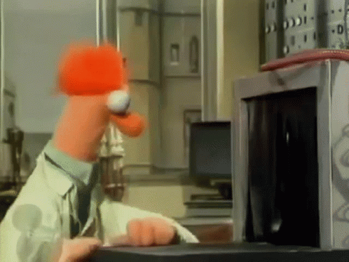 A Cartoon Character Is Using A Microwave Oven GIF