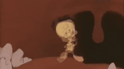 A Cartoon Character Is Walking Through A Cave While Holding A Sword . GIF