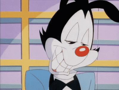 A Cartoon Character Is Wearing A Tuxedo And Making A Face . GIF