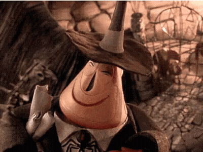 A Cartoon Character Is Wearing A Witch Hat And Holding A Spider . GIF