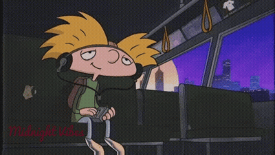 A Cartoon Character Is Wearing Headphones While Sitting On A Bus . GIF