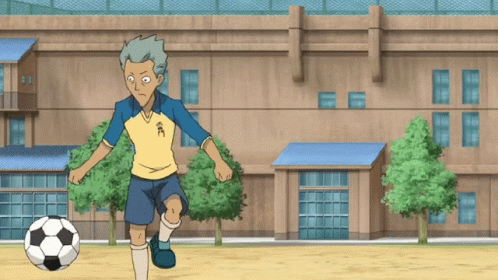 A Cartoon Character Kicks A Soccer Ball In Front Of A Building With Chinese Characters On It GIF