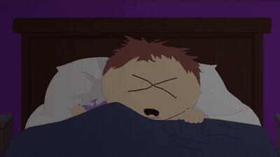 A Cartoon Character Laying In Bed With His Eyes Crossed GIF