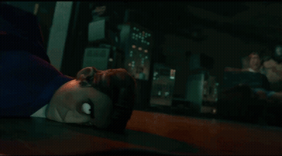 A Cartoon Character Laying On The Floor With A Crowd Behind Him GIF