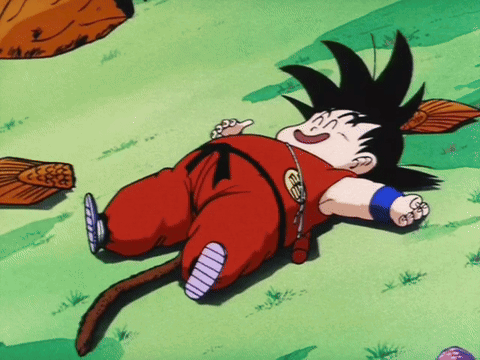 A Cartoon Character Laying On The Ground With A Tail And A Necklace That Says ' Goku ' On It GIF