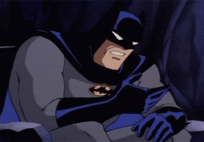 A Cartoon Character Named Batman Is Sitting Down With His Head Resting On His Arm GIF