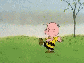 A Cartoon Character Named Charlie Brown Is Running On A Grassy Field GIF