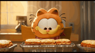 A Cartoon Character Named Garfield Is Sitting At A Table Eating Sandwiches GIF