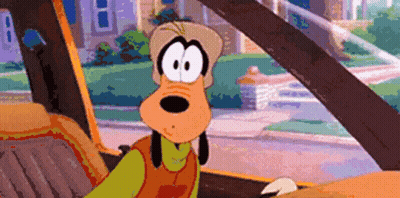 A Cartoon Character Named Goofy Is Sitting In The Driver 'S Seat Of A Car GIF