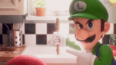A Cartoon Character Named Luigi Is Pointing At Something In A Kitchen GIF