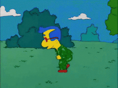 A Cartoon Character Named Milhouse Simpson Is Walking Through A Grassy Field GIF