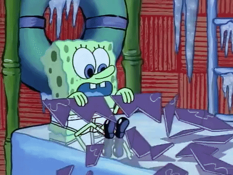 A Cartoon Character Named Spongebob Is Sitting On A Table Holding A Piece Of Ice . GIF