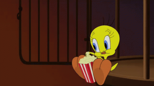 A Cartoon Character Named Tweety Is Holding A Popcorn Bucket GIF
