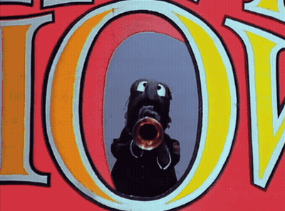 A Cartoon Character Playing A Trumpet In Front Of The Word Joy GIF