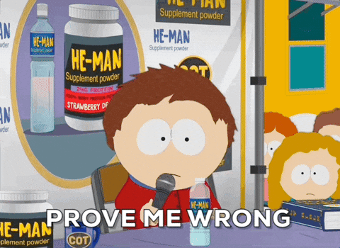 A Cartoon Character Says Prove Me Wrong While Holding A Microphone In Front Of A Bottle Of He-Man Supplement Powder GIF