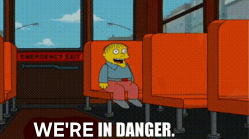 A Cartoon Character Sits On A Bus With The Words We 'Re In Danger GIF