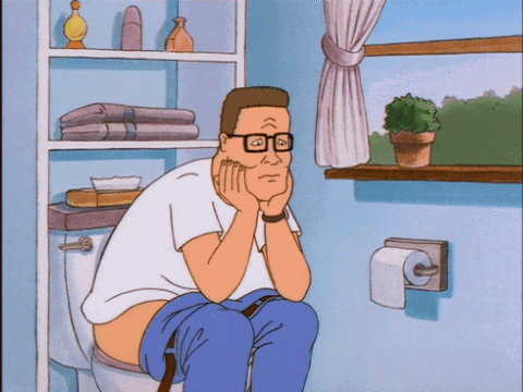 A Cartoon Character Sits On A Toilet With His Hands On His Face GIF