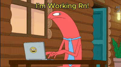 A Cartoon Character Sitting At A Desk With A Laptop And The Words I 'M Working Rn GIF