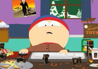 A Cartoon Character Sitting At A Desk With A Sign That Says Stan 'S Toys In The Background GIF