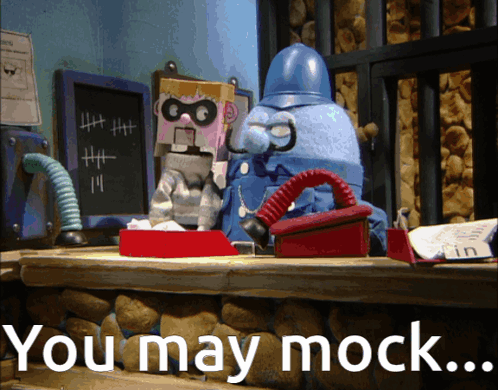 A Cartoon Character Sitting At A Desk With The Words You May Mock GIF