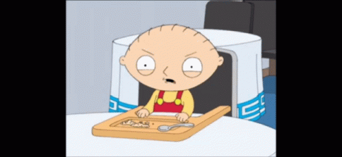 A Cartoon Character Sitting At A Table With A Cutting Board GIF