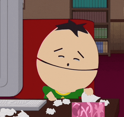 A Cartoon Character Sitting In Front Of A Computer With A Box Of Tissues GIF