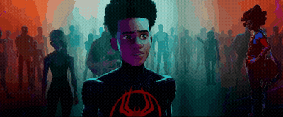 A Cartoon Character Stands In Front Of A Crowd With A Red Eye On His Chest GIF