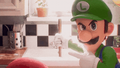 A Cartoon Character Wearing A Green Hat With A L On It GIF