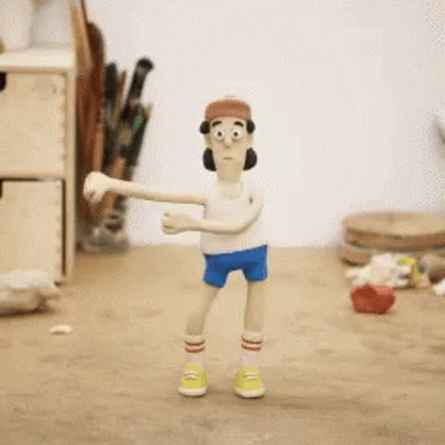 A Cartoon Character Wearing A Hat And Shorts Is Standing On A Wooden Table GIF