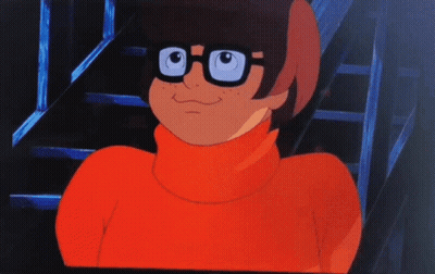 A Cartoon Character Wearing A Red Turtleneck And Glasses GIF